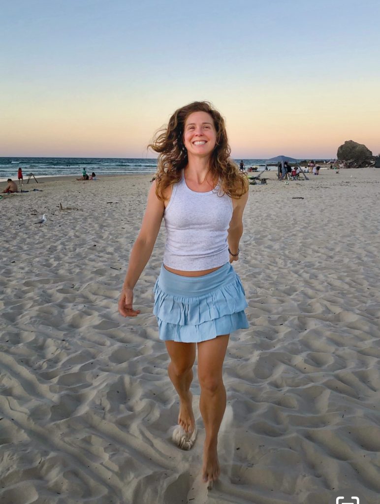 Jessica Valiant on a beach walking in Australia
